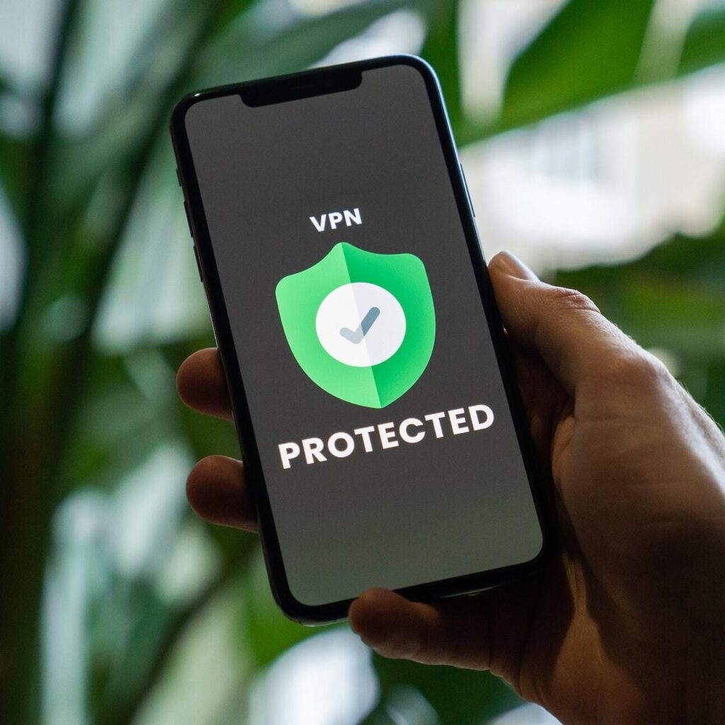 A hand holding a phone with a VPN protected sign