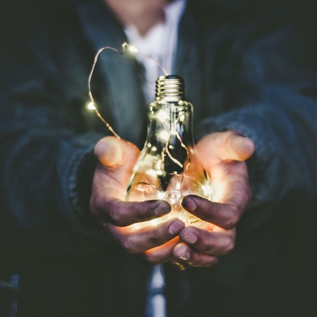 A man holding a bulb in his hands