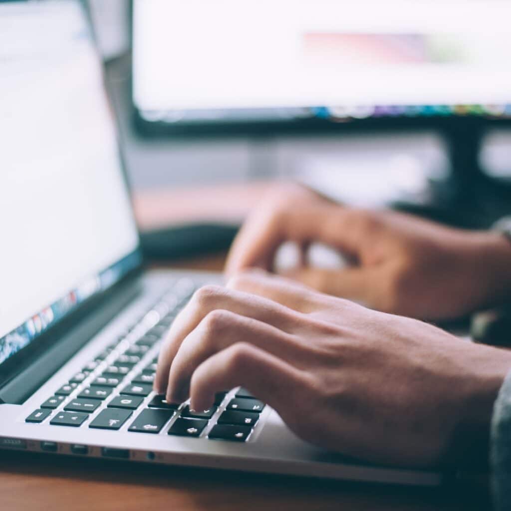 A man typing on the laptop